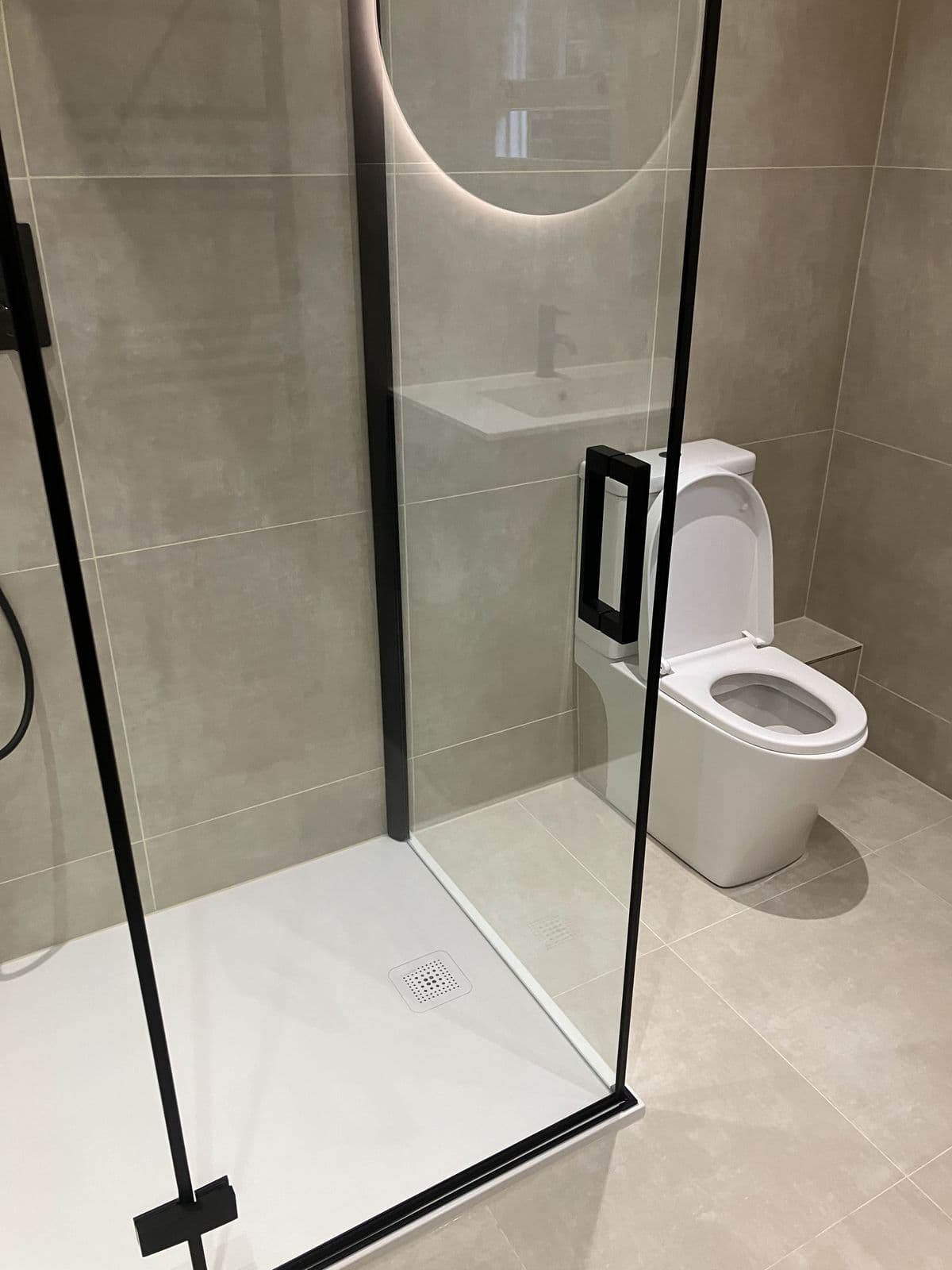 Completed bathroom renovation - freestanding bathtub and tiled surround