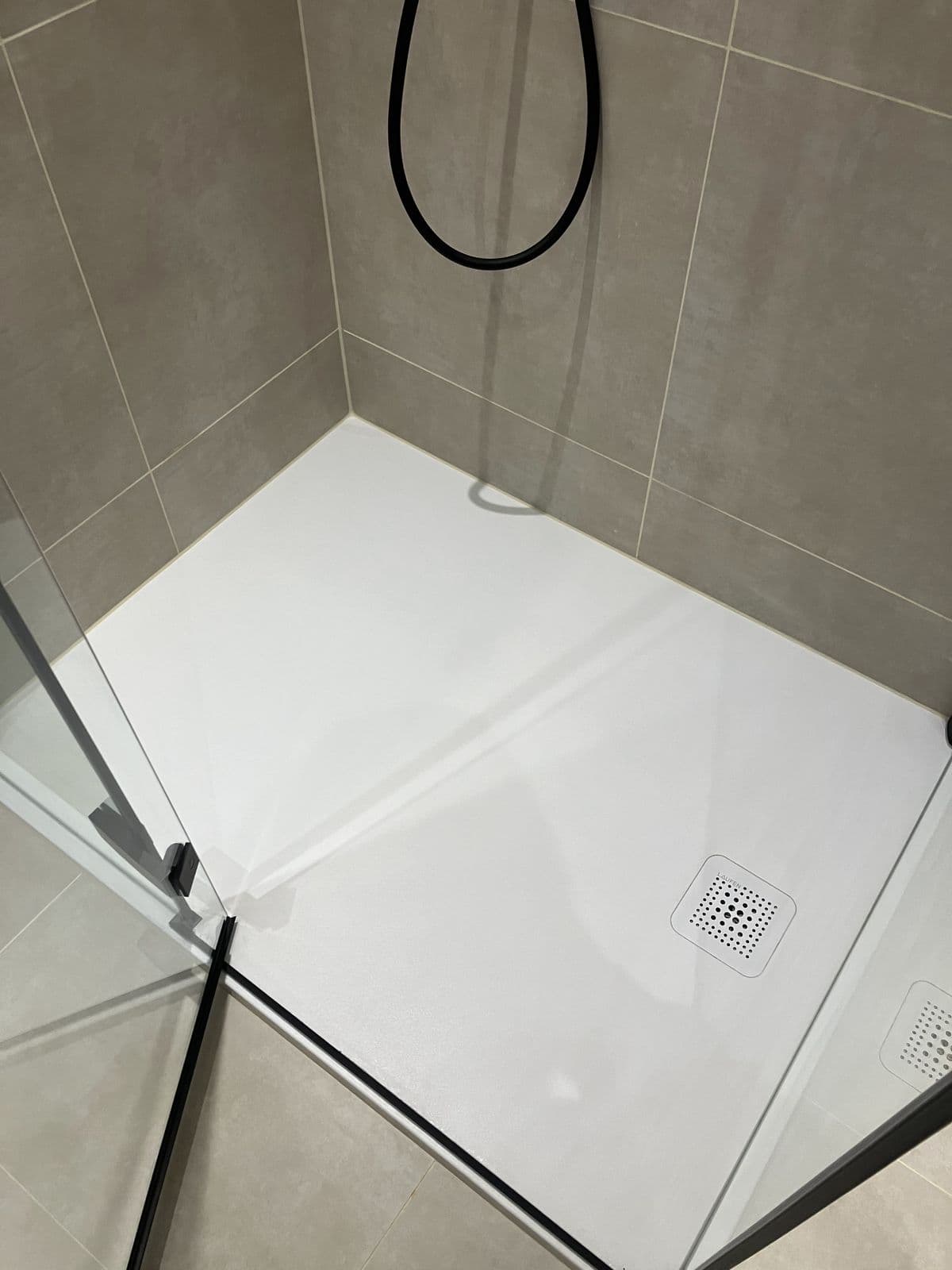 Completed bathroom renovation - heated towel rail and tiled wall