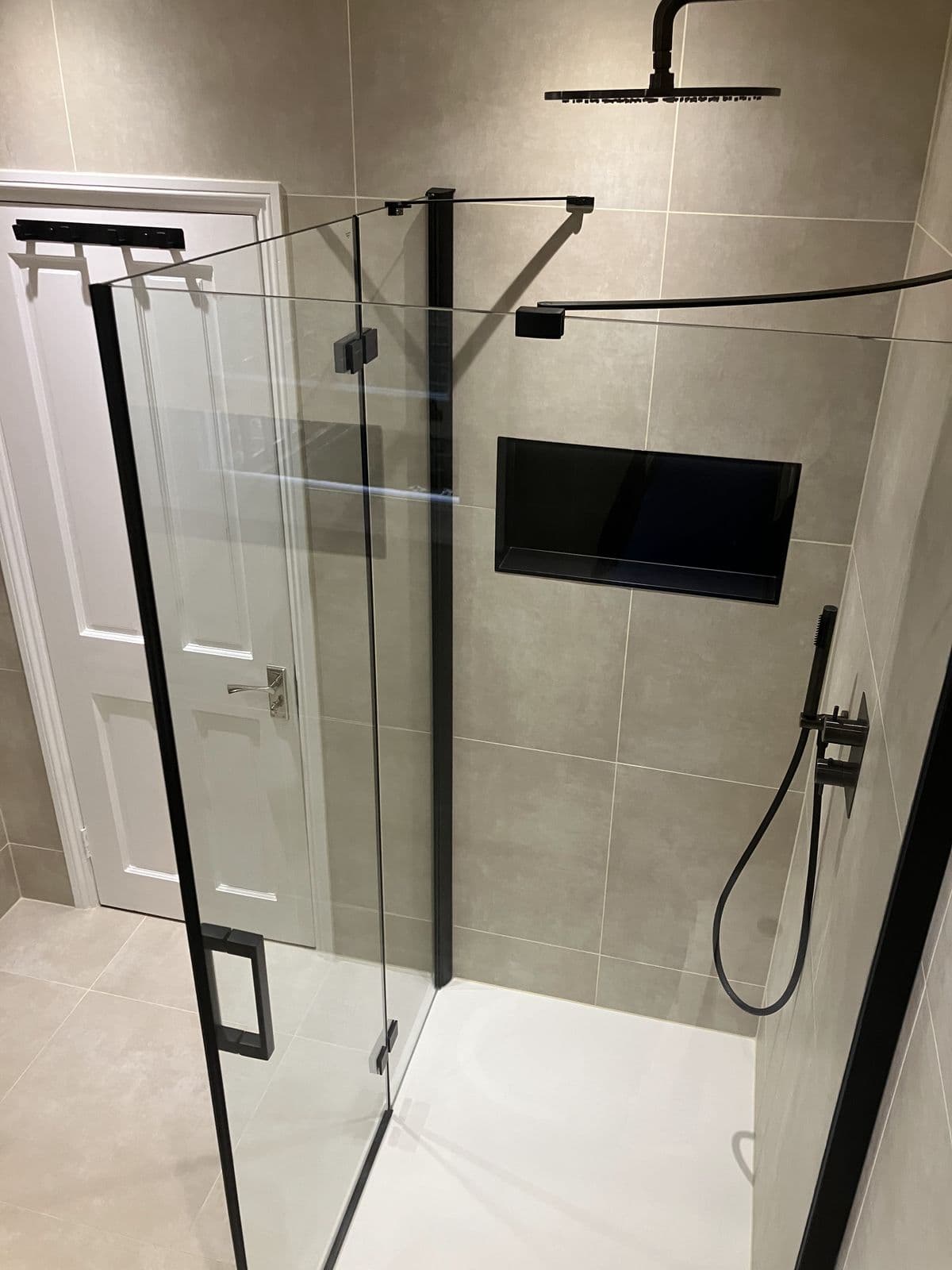 Completed bathroom renovation - recessed shower niche with feature tiling