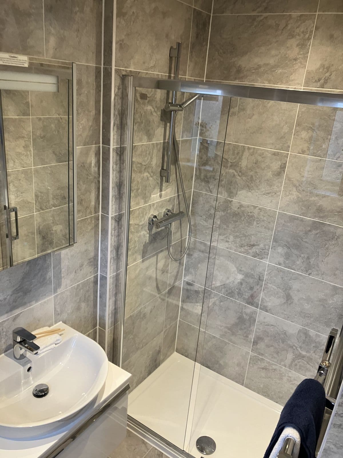 Completed bathroom renovation - feature tiling and lighting detail