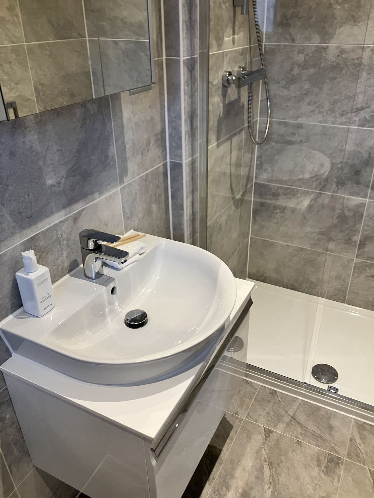 Completed bathroom renovation - bath panel and tiled surround