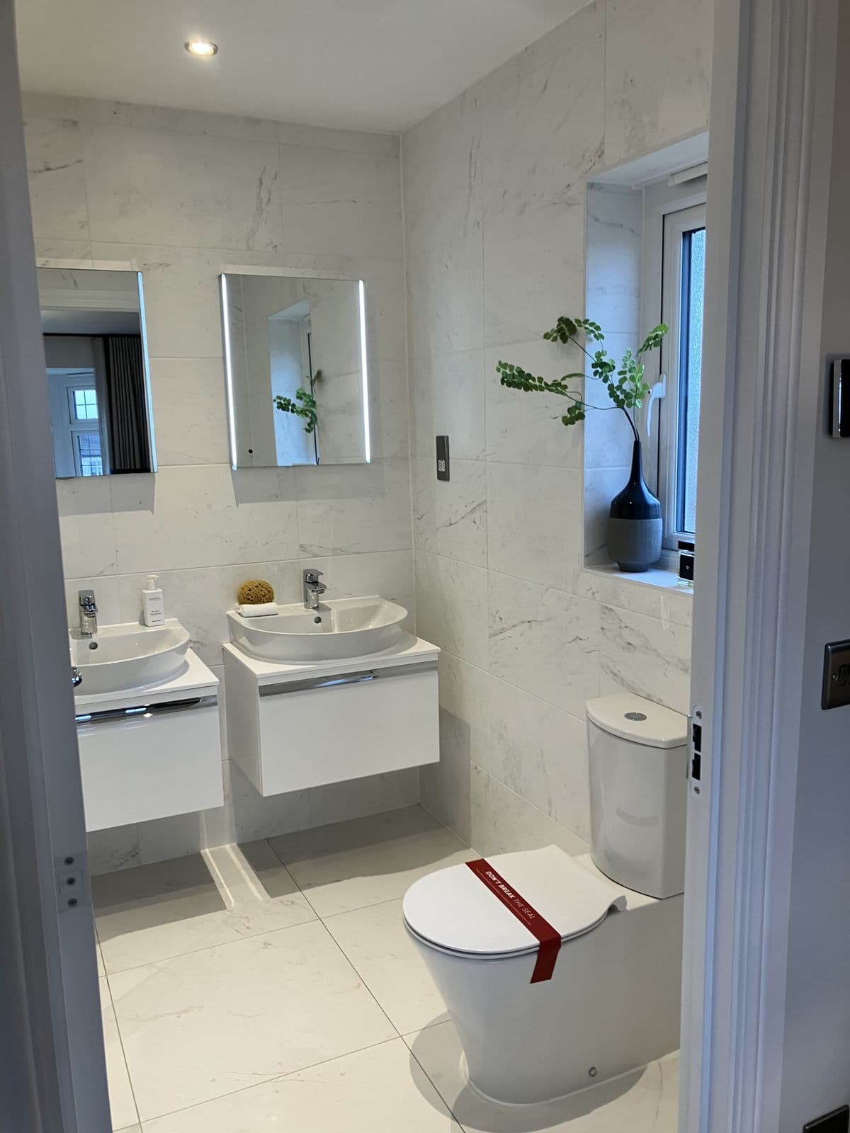 Completed bathroom renovation - tiled splashback and chrome fittings