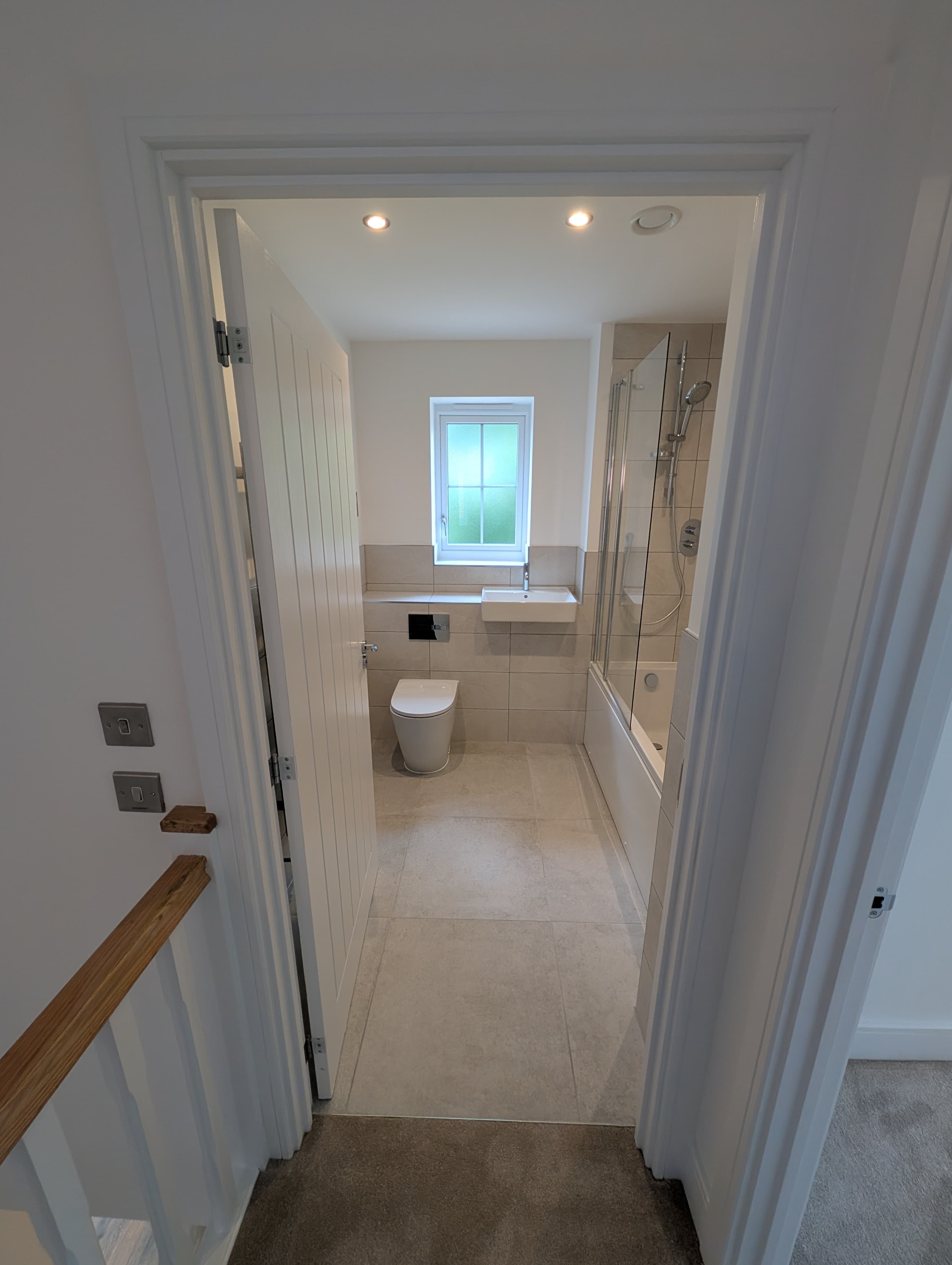Bathroom with bathtub, glass shower screen and window