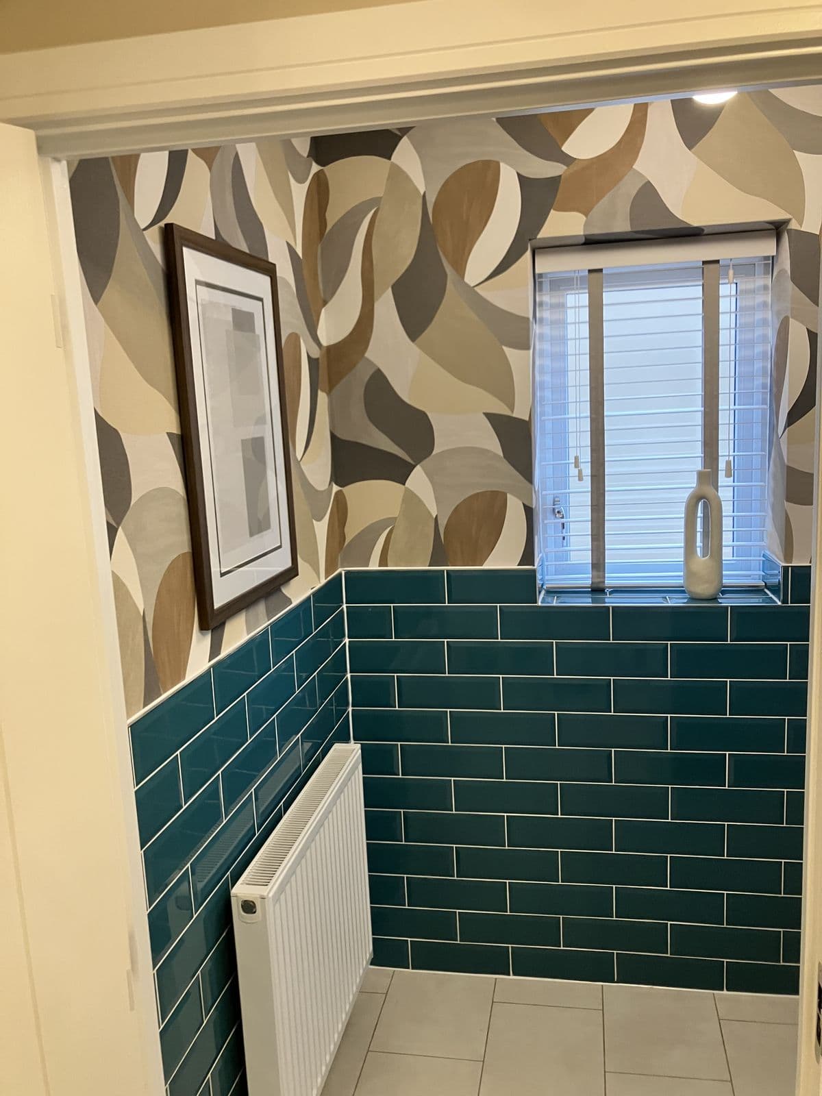 Bathroom renovation detail - heated towel rail and tiled wall