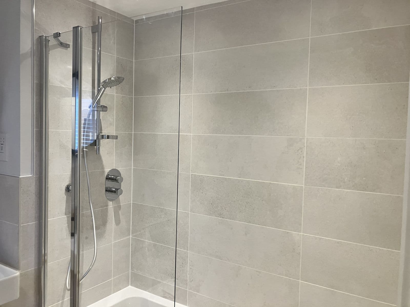 Bathroom renovation detail - tiled splashback and chrome fittings